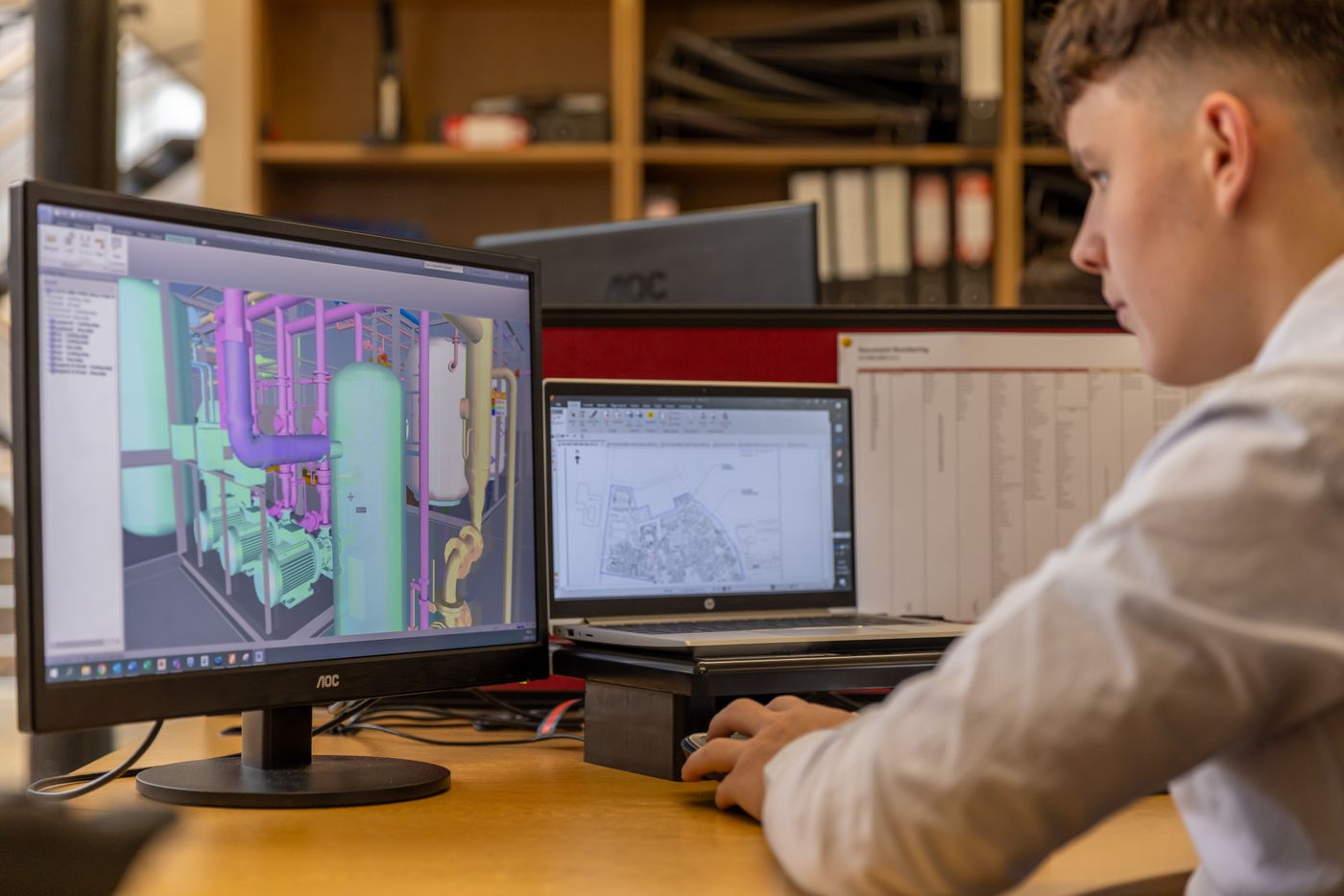 Engineer working with a technical model at a computer.