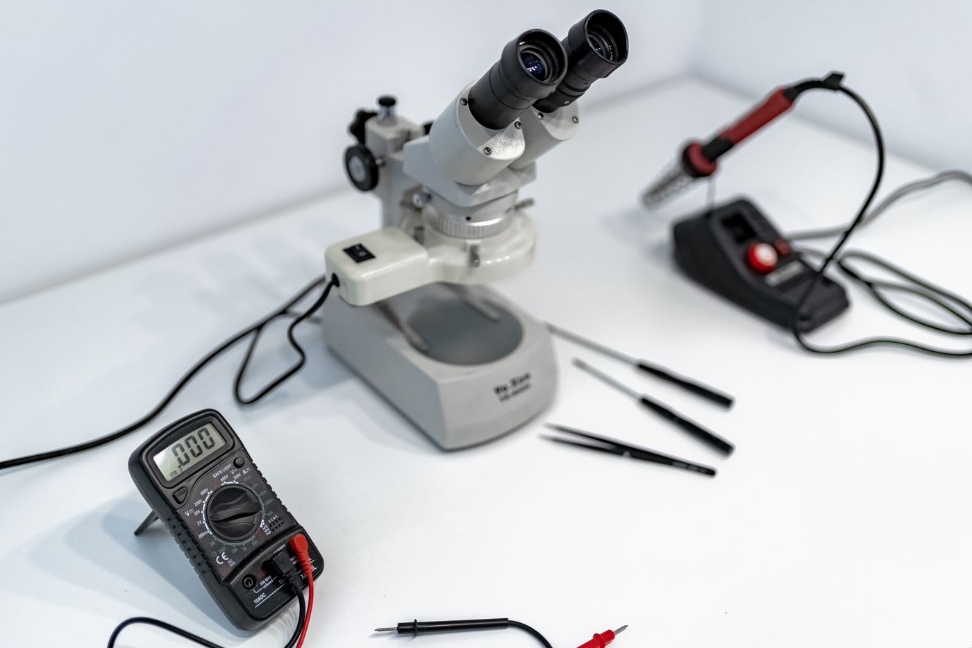 Microscope and electronic measurement tools for detailed component inspection.
