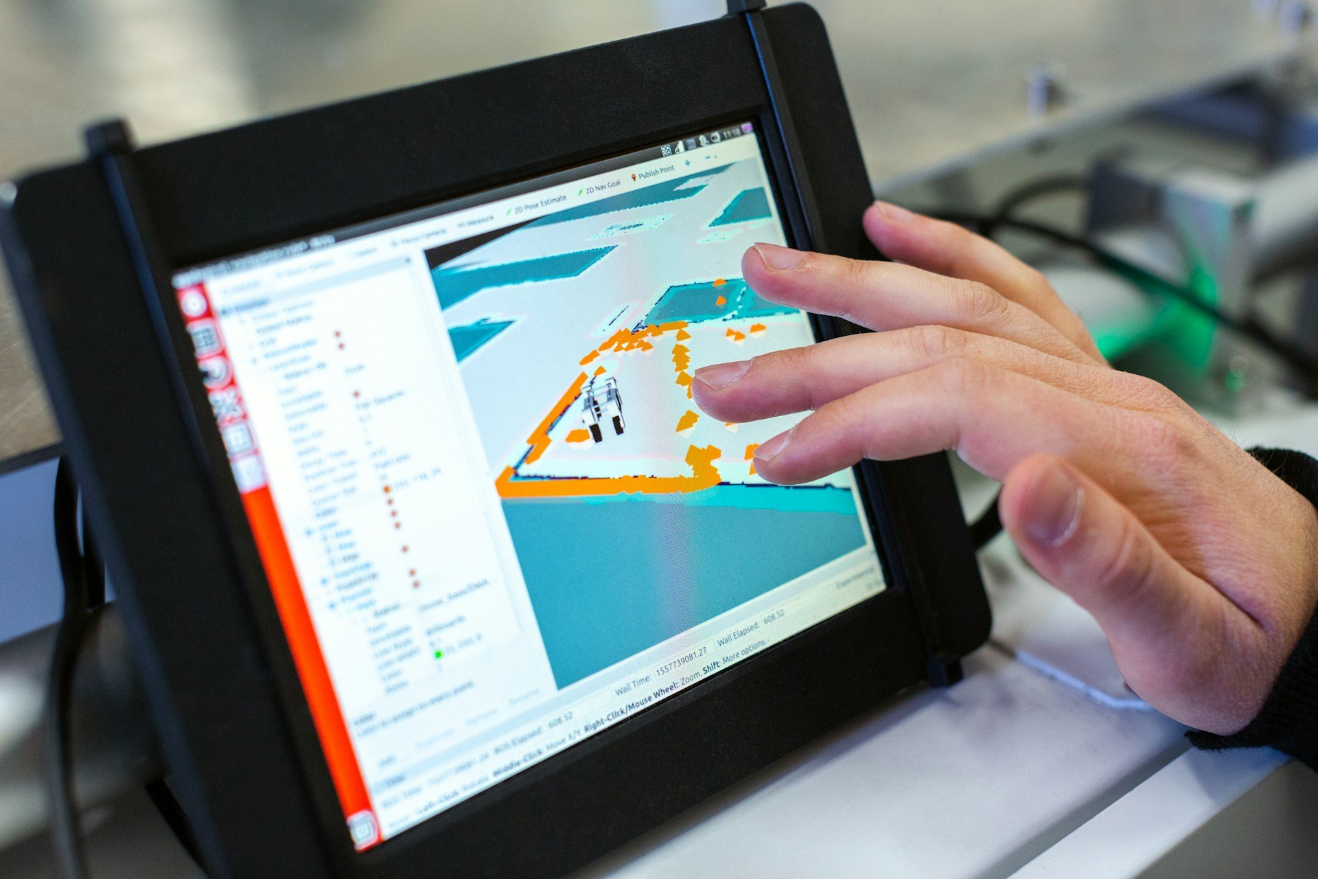 Engineer using a tablet with a live 3D cell model at the production equipment.